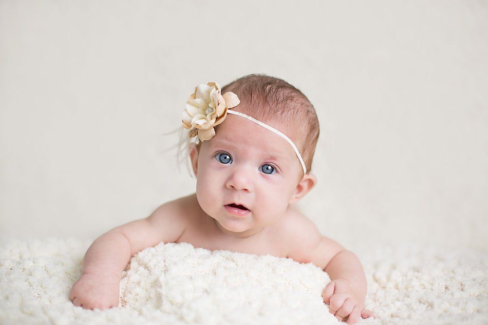 Three month old photos of baby girl wearing floral headband by Pueblo baby photographer.