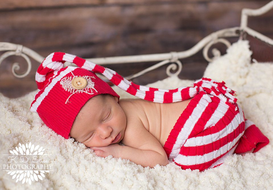 Christmas themed newborn photo of sleeping baby boy by Pueblo newborn photographer K.D. Elise Photography.