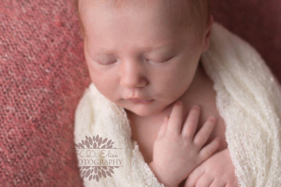 Close up photograph of newborn baby girl's face and eyelashes by Pueblo baby photographer K.D. Elise Photography