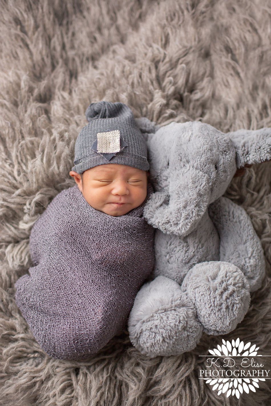 Newborn baby boy laying wrapped up snug next to his special stuffed animal by Colorado Springs Newborn Photographer.
