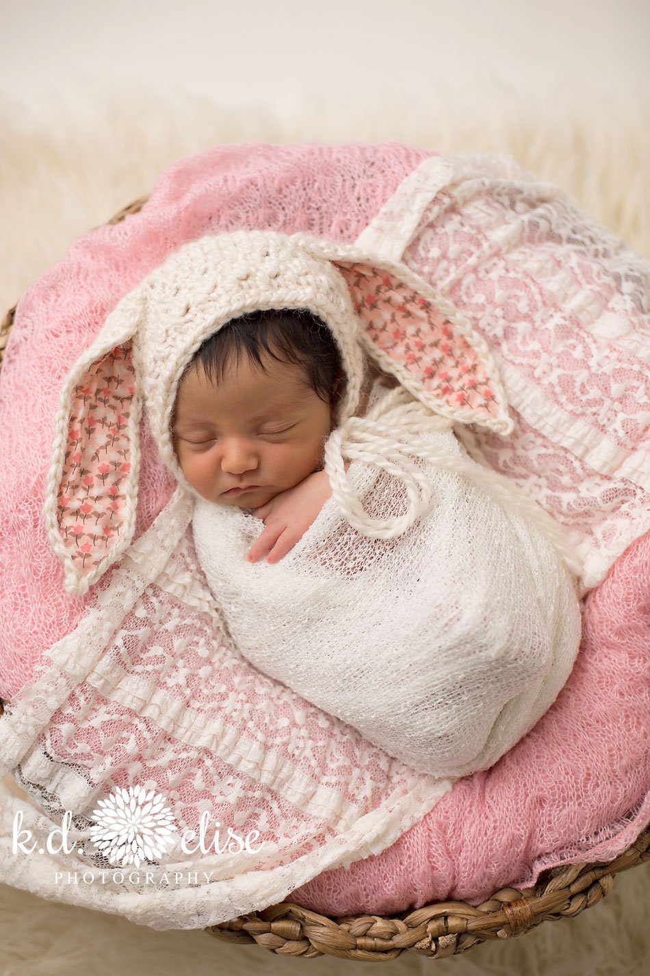 Newborn baby in a basket, wearing a bunny hat by Colorado Springs newborn photographer K.D. Elise Photography.