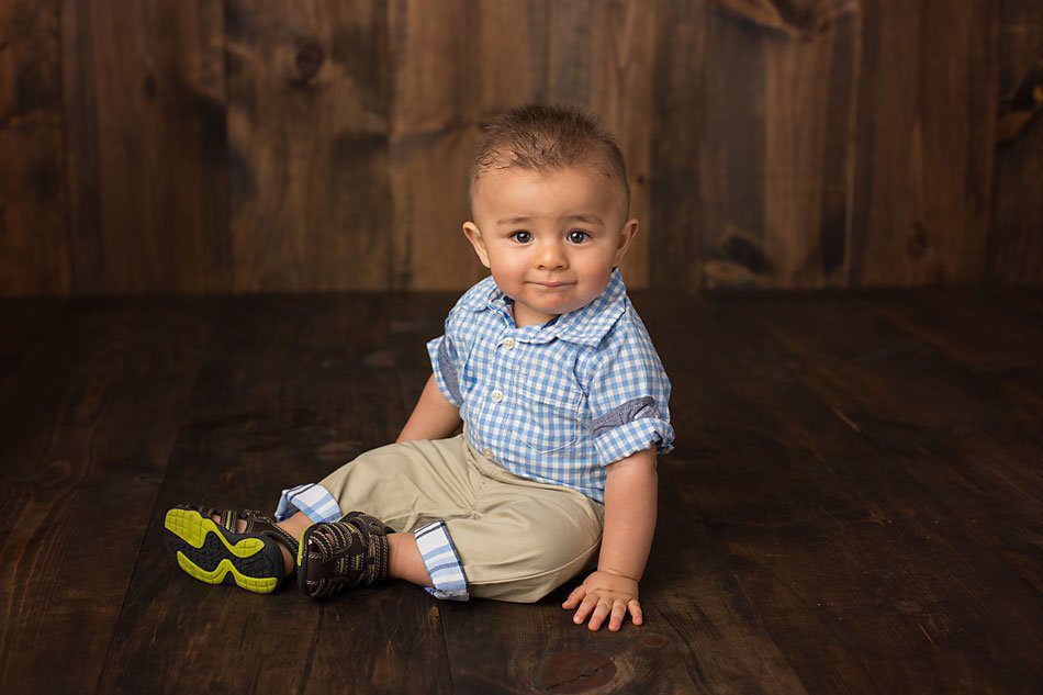 Baby boy on wood floor, baby photography by Pueblo Children's photographer K.D. Elise Photography.