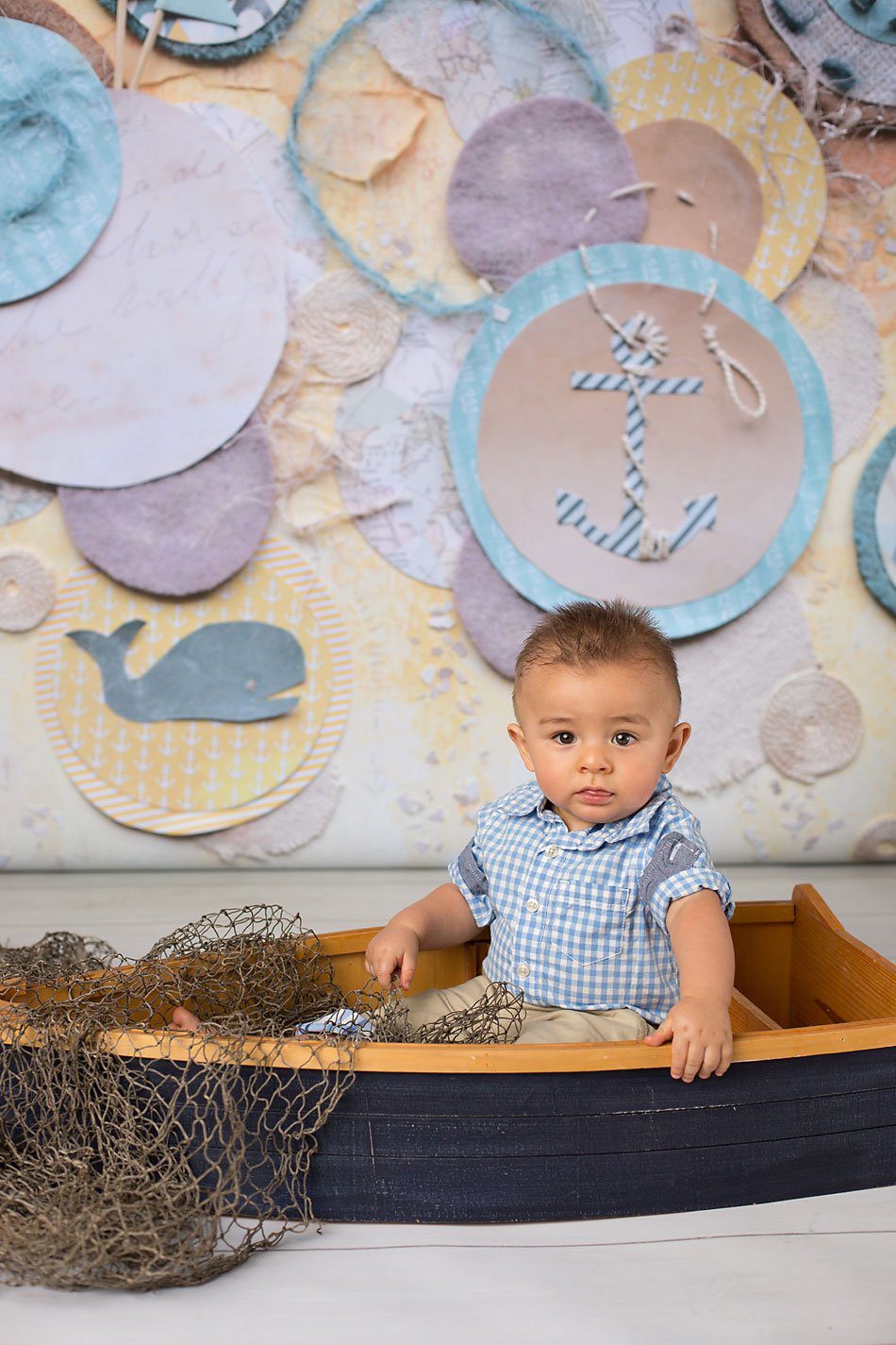 Baby boy in a boat, nautical themed session by Pueblo Children's photographer K.D. Elise Photography.