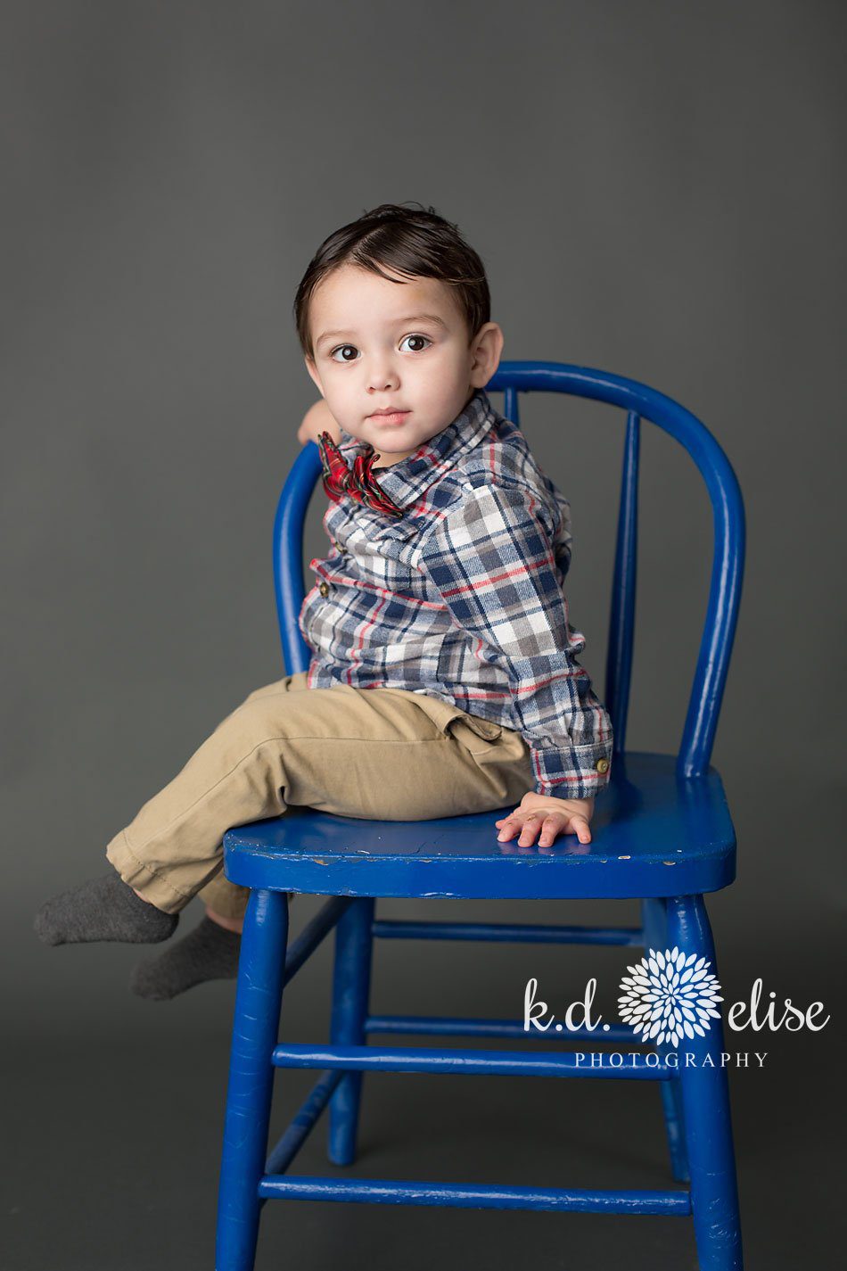 Little boy in plaid and a boy tie. Nerd themed children's photography session by Pueblo children's photographer K.D. Elise Photography.