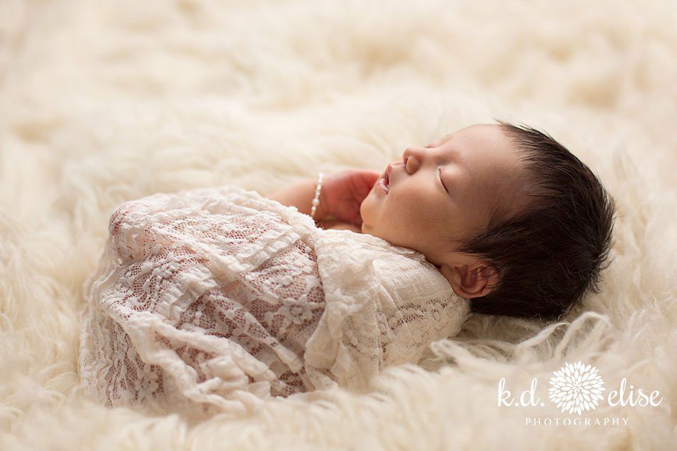 Baby girl in cream and fur by Pueblo newborn photographer K.D. Elise Photography.