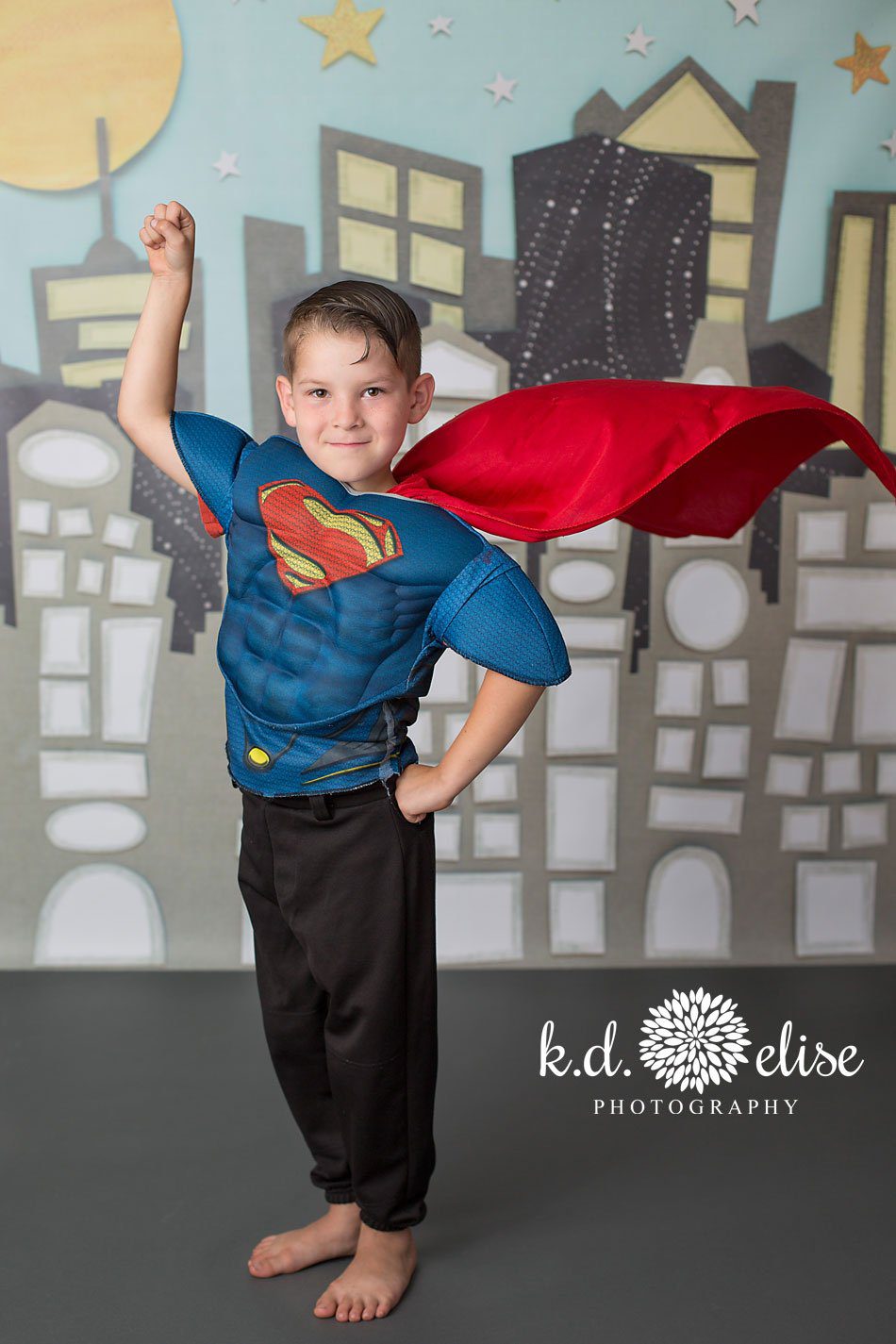Superhero themed mini sessions featuring a cityscape background.