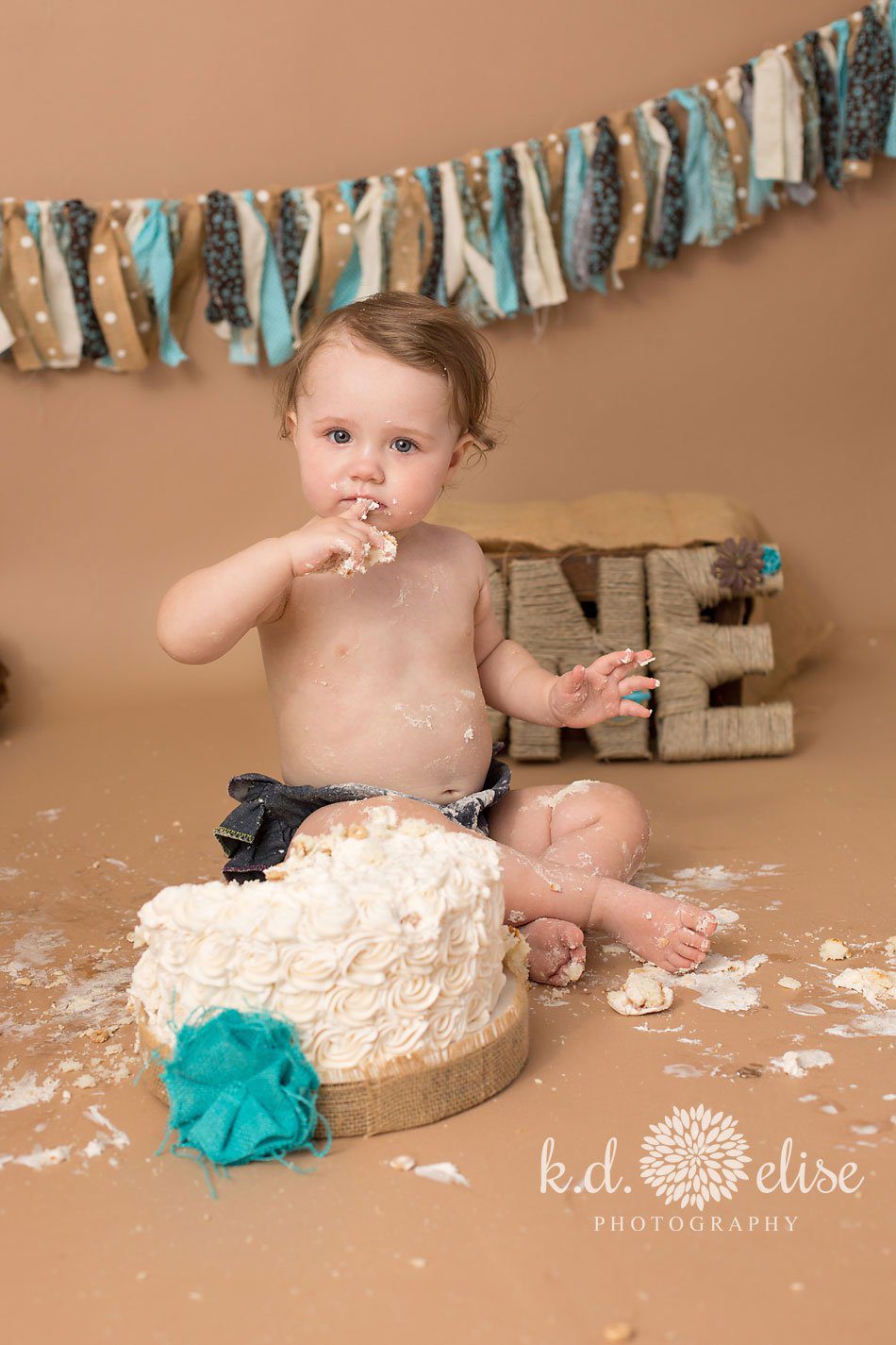 Brown and turquoise rustic themed first birthday cake smash session. 