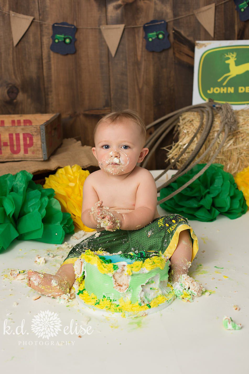 John Deere themed first birthday cake smash session by Pueblo baby photographer K.D. Elise Photography.