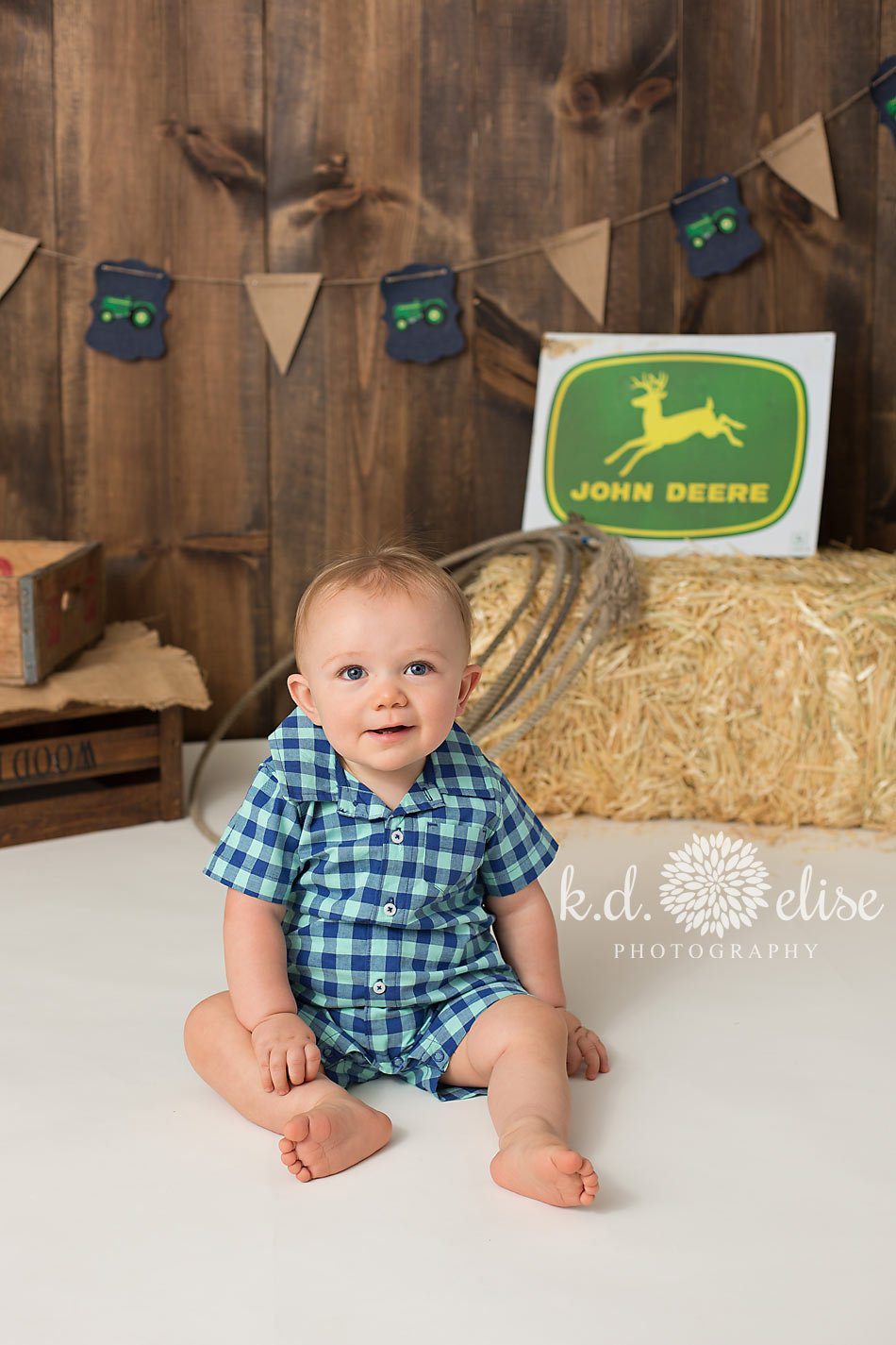One year old Jack poses for his John Deere themed first birthday photos.