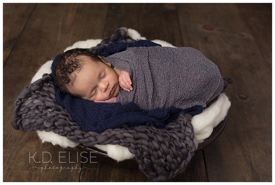 Baby boy laying on his side during newborn portraits with Pueblo and Colorado Springs newborn photographer K.D. Elise Photography.