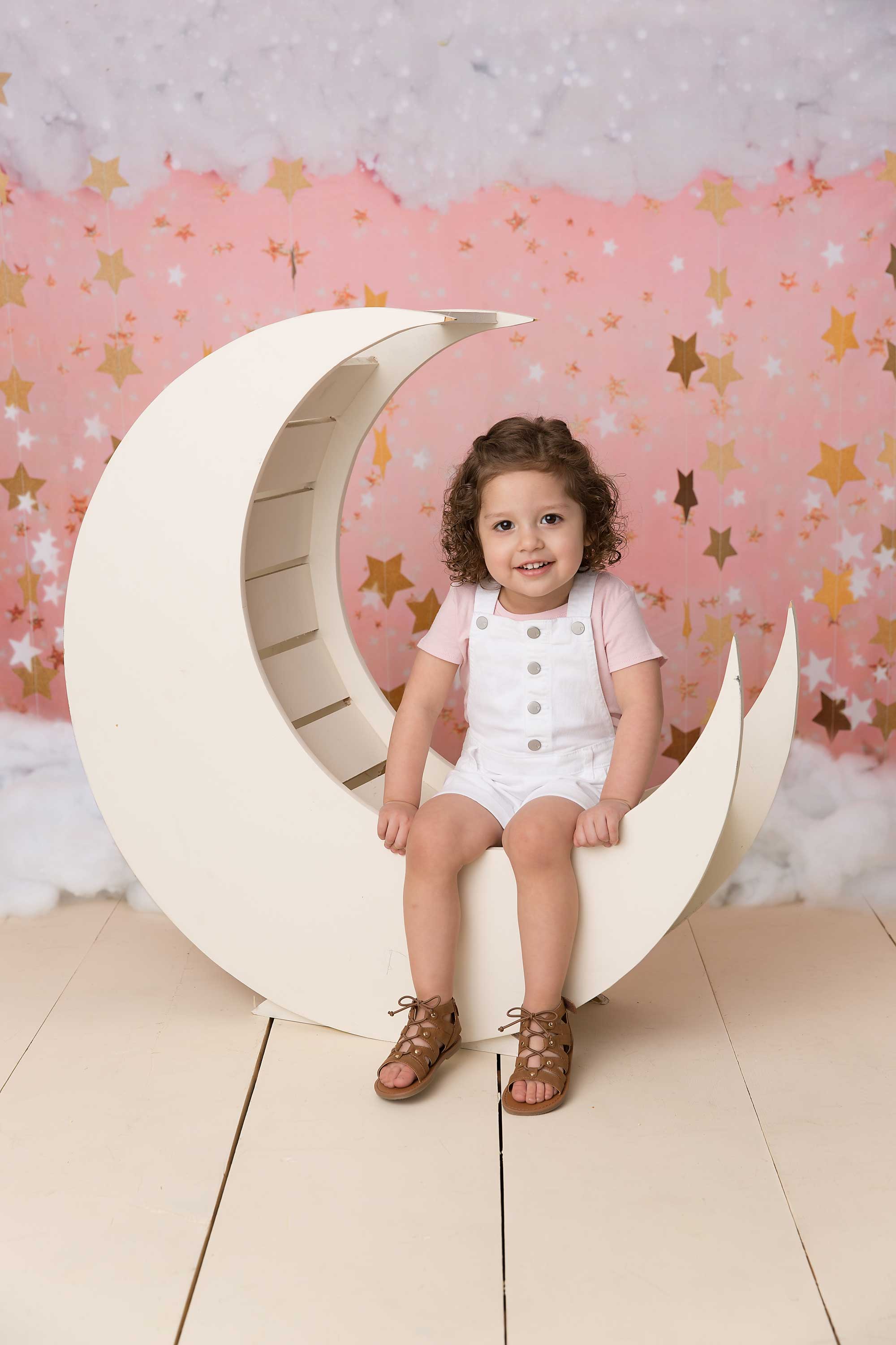 Three year old little girl sitting in a moron prop.