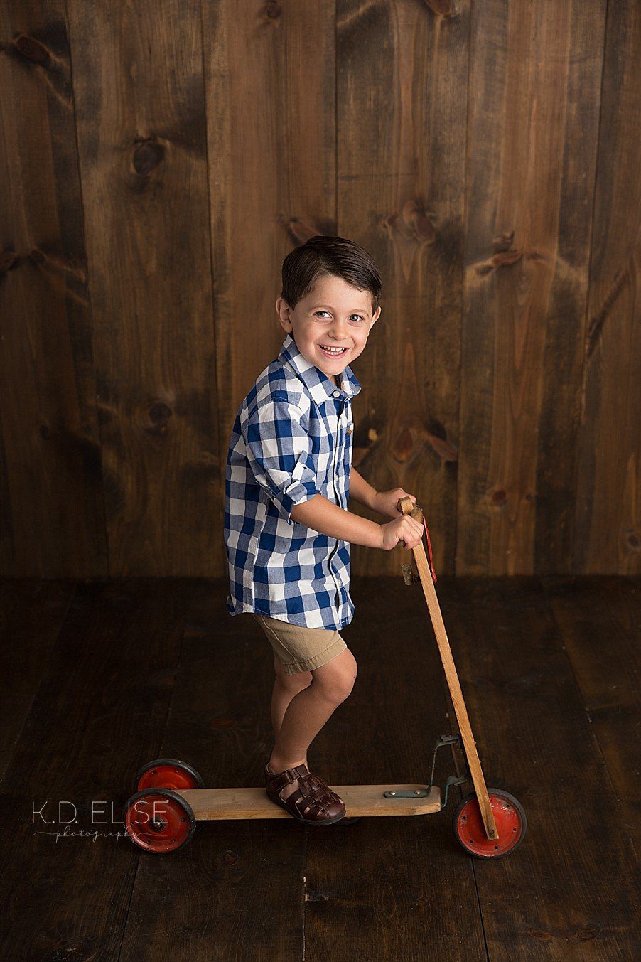 Little boy on a vintage scooter.